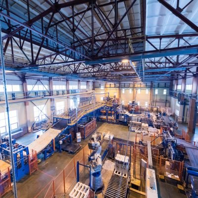 Factory workshop interior and machines on glass production background